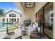 Covered patio featuring comfortable seating, an elegant chandelier, and a view of the pool area at 3426 Cocard Ct, Windermere, FL 34786