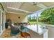 Large covered patio with an outdoor bar, dining area, and comfortable lounge seating with fans at 3426 Cocard Ct, Windermere, FL 34786