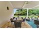 Covered patio featuring outdoor seating, a ceiling fan, and a view of the lush backyard at 3426 Cocard Ct, Windermere, FL 34786