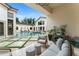 Beautiful outdoor patio with a seating area, manicured lawn, and a lovely pool view at 3426 Cocard Ct, Windermere, FL 34786