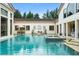 Tranquil backyard pool with a spa, patio seating, and an expansive view of the home at 3426 Cocard Ct, Windermere, FL 34786