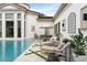 Stunning backyard pool and patio featuring a large pool, spa, and manicured lawn at 3426 Cocard Ct, Windermere, FL 34786