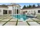 Backyard pool and spa featuring lush landscaping, a spacious patio, and elegant design at 3426 Cocard Ct, Windermere, FL 34786