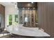 An elegant home wine bar with a marble countertop, decorative shelves, and a glass-enclosed wine room at 3426 Cocard Ct, Windermere, FL 34786