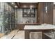 Well-stocked wine cellar featuring a glass-enclosed wine room, custom cabinets, marble countertop and floors at 3426 Cocard Ct, Windermere, FL 34786