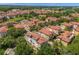 Community aerial featuring lush landscaping, terracotta roofs, and a tranquil pond with fountain at 3508 Porta Romano Way, Lake Mary, FL 32746