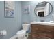 Stylish powder room featuring blue walls, modern vanity, and elegant decor at 3508 Porta Romano Way, Lake Mary, FL 32746