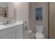 Bathroom featuring a vanity with a marble countertop, with a toilet and walk-in shower at 3508 Porta Romano Way, Lake Mary, FL 32746