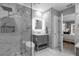 Modern bathroom featuring marble tile, rainfall shower, sleek vanity, and contemporary lighting for a serene atmosphere at 3508 Porta Romano Way, Lake Mary, FL 32746