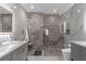 Sleek bathroom with double vanity, mosaic tile shower, and modern fixtures, offering a luxurious spa-like experience at 3508 Porta Romano Way, Lake Mary, FL 32746