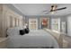 Bedroom with large bed, neutral carpeting, abundant natural light, and modern artwork, creating a relaxing atmosphere at 3508 Porta Romano Way, Lake Mary, FL 32746
