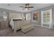 Bedroom with large bed, neutral carpeting, abundant natural light, and modern artwork, creating a relaxing atmosphere at 3508 Porta Romano Way, Lake Mary, FL 32746
