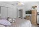 Bright bedroom featuring carpet floors, modern ceiling fan, light walls, and a beautiful wardrobe cabinet at 3508 Porta Romano Way, Lake Mary, FL 32746