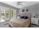 Serene bedroom with shuttered windows, plush bedding, and a ceiling fan at 3508 Porta Romano Way, Lake Mary, FL 32746