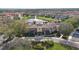 Aerial view showcasing the community clubhouse with lush landscaping, and a serene pond at 3508 Porta Romano Way, Lake Mary, FL 32746