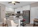 Bright kitchen featuring white cabinets, stainless appliances, granite countertops, and island seating at 3508 Porta Romano Way, Lake Mary, FL 32746