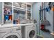 Bright laundry room featuring storage shelves, counter space, washer, and dryer at 3508 Porta Romano Way, Lake Mary, FL 32746