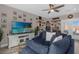Inviting living room with comfortable blue seating, large TV, stylish decor, and plenty of natural light at 3508 Porta Romano Way, Lake Mary, FL 32746