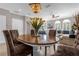 Open dining and living room showcasing wood table, sectional sofa, and natural lighting at 3508 Porta Romano Way, Lake Mary, FL 32746