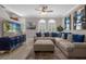 Bright living room featuring large sectional sofa, ceiling fan, and natural light from arched windows at 3508 Porta Romano Way, Lake Mary, FL 32746