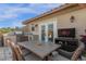 Outdoor kitchen on the patio with stainless grill, dining table, and TV at 3508 Porta Romano Way, Lake Mary, FL 32746