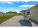 A view of the sunny backyard with patio table and chairs at 3936 Silverstream Ter, Sanford, FL 32771