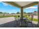 Great covered back patio with black wrought iron table and chairs at 3936 Silverstream Ter, Sanford, FL 32771
