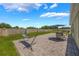 Backyard featuring a paver patio, ideal for outdoor dining and lounging beneath a shady umbrella at 3936 Silverstream Ter, Sanford, FL 32771