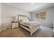 Cozy bedroom with a comfortable bed, neutral walls, and a window for natural light at 3936 Silverstream Ter, Sanford, FL 32771