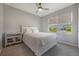 Light-filled bedroom with a ceiling fan and window view at 3936 Silverstream Ter, Sanford, FL 32771