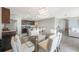 Bright dining area features modern light fixture, a glass table and direct access to the kitchen at 3936 Silverstream Ter, Sanford, FL 32771