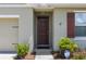Close-up of the inviting front entrance with a dark-stained front door, and security camera above at 3936 Silverstream Ter, Sanford, FL 32771