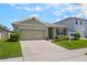 Inviting one-story home featuring a driveway, lush lawn, and tidy landscaping for enhanced curb appeal at 3936 Silverstream Ter, Sanford, FL 32771
