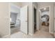 Hallway view, bathroom, laundry room and bedroom with neutral walls and tiled floor at 3936 Silverstream Ter, Sanford, FL 32771