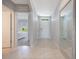 Bright hallway with tile flooring, a front door view, and bedroom access at 3936 Silverstream Ter, Sanford, FL 32771