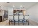 Modern kitchen with a kitchen island surrounded by four barstools, perfect for casual dining and socializing at 3936 Silverstream Ter, Sanford, FL 32771