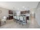 Bright kitchen featuring a kitchen island with bar stool seating, stainless steel appliances, and sleek dark cabinetry at 3936 Silverstream Ter, Sanford, FL 32771