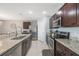 Modern kitchen featuring stainless steel appliances, granite countertops, and ample cabinet space at 3936 Silverstream Ter, Sanford, FL 32771