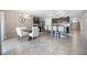 A spacious kitchen featuring a kitchen island and dining area with white chairs, great for Gathering gatherings at 3936 Silverstream Ter, Sanford, FL 32771