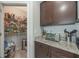 Walk-in pantry with shelving and storage space next to kitchen's countertop with appliances at 3936 Silverstream Ter, Sanford, FL 32771