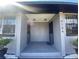 View of the gray painted entrance featuring security doors, white gravel and decorative shrubs at 4204 Columbia St, Orlando, FL 32811
