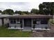 Charming one-story home featuring gray paint, window security bars, and landscaping at 4204 Columbia St, Orlando, FL 32811