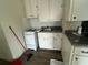 An open kitchen features white cabinets and a stainless steel sink at 4204 Columbia St, Orlando, FL 32811