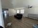 Spacious living room features wood flooring, ceiling fans, and lots of natural light from two windows at 4204 Columbia St, Orlando, FL 32811