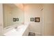 Bathroom with double sink vanity, large mirror, and neutral decor at 4858 Magnetite Loop, Mount Dora, FL 32757