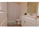 Well-lit bathroom featuring a shower-tub combination with patterned curtain, a modern vanity, and updated fixtures at 4858 Magnetite Loop, Mount Dora, FL 32757