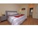 Bedroom with wood floors, comfortable bed, two nightstands and soft natural light at 4858 Magnetite Loop, Mount Dora, FL 32757