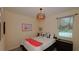 Charming bedroom features modern lighting, a comfortable bed, and a window that provides natural light, creating a tranquil space at 4858 Magnetite Loop, Mount Dora, FL 32757