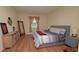 Inviting bedroom with wood floors, comfortable bed, dresser, and natural light at 4858 Magnetite Loop, Mount Dora, FL 32757