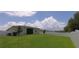 Backyard view featuring a well-maintained lawn and white vinyl fencing for added privacy at 4858 Magnetite Loop, Mount Dora, FL 32757